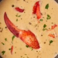 Lobster Bisque · brandy scented lobster cream, hint of truffle, tender lobster meat, and herb croutons