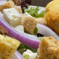 Tossed · Mixed greens, house-made croutons, red onions, bleu cheese crumble and a balsamic vinaigrette.