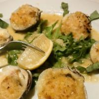 Baked Clams · Whole little neck clams baked with seasoned breadcrumbs in lemon and white wine.