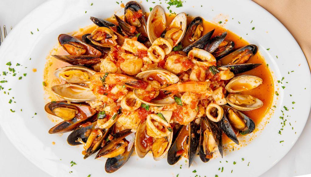 Seafood Risotto · Risotto sauteed with clams, mussels, shrimp, scallops and calamari in a shallots cognac sauce with a touch of marinara.