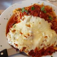 Veal Parmigiana · Breaded veal cutlet with tomato sauce and melted mozzarella cheese.