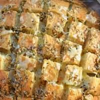 Garlic Bread With Cheese · A cross between garlic bread and pizza, cheesy bread is a quick, easy, and delicious party s...