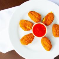 Jalapeño Poppers · 6 pieces. Juicy jalapeño poppers breaded and filled with cheese and fried to golden perfecti...