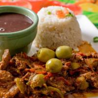 Ropa Vieja Plato · Braised beef with sautéed onions, olives, peppers, rice, and beans.