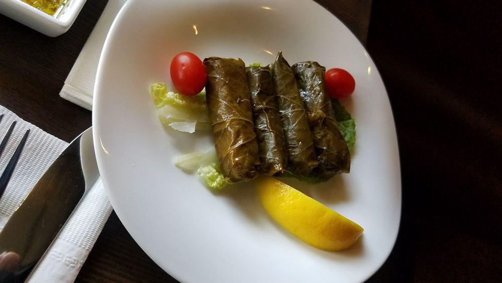 Grape Leaves · Grape leaves stuffed with rice, tomato, mint, lemon, parsley, and seasoning cooked in olive oil.