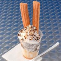 Churro Sundae · 3 scoops of Vanilla  ice cream, carmel, crunchies, whipped cream and two cinnamon churros