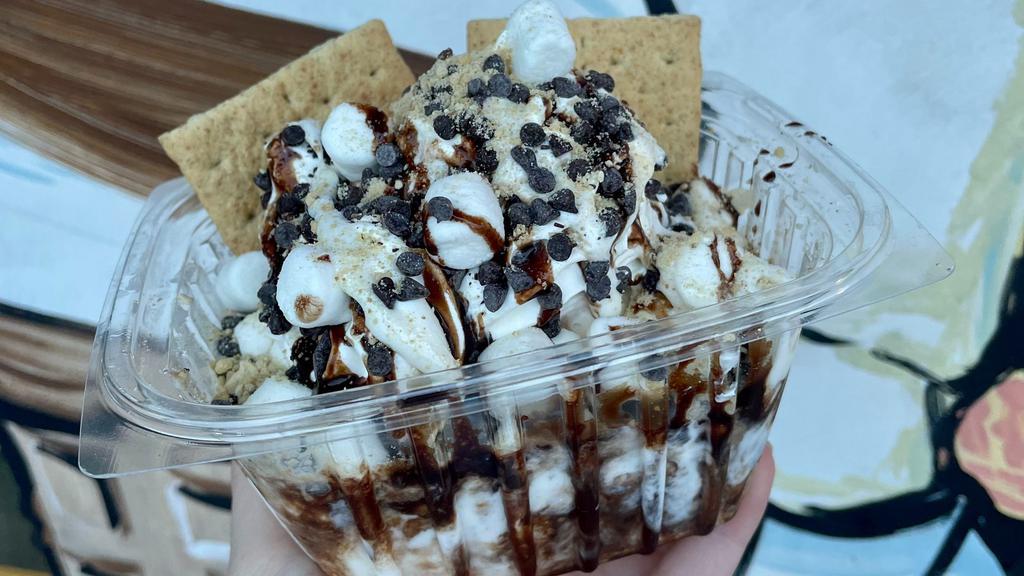 Some S'Mores Sundae · 3 scoops of Vanilla Fudge Ice Cream topped with chocolate syrup, marshmallow sauce, chocolate chips, mini marshmallows, graham cracker and whipped cream