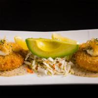 Lump Crab Cakes · Lump crab meat, Dijon, honey, and shallots, severed with homemade “remoulade” sauce and cole...