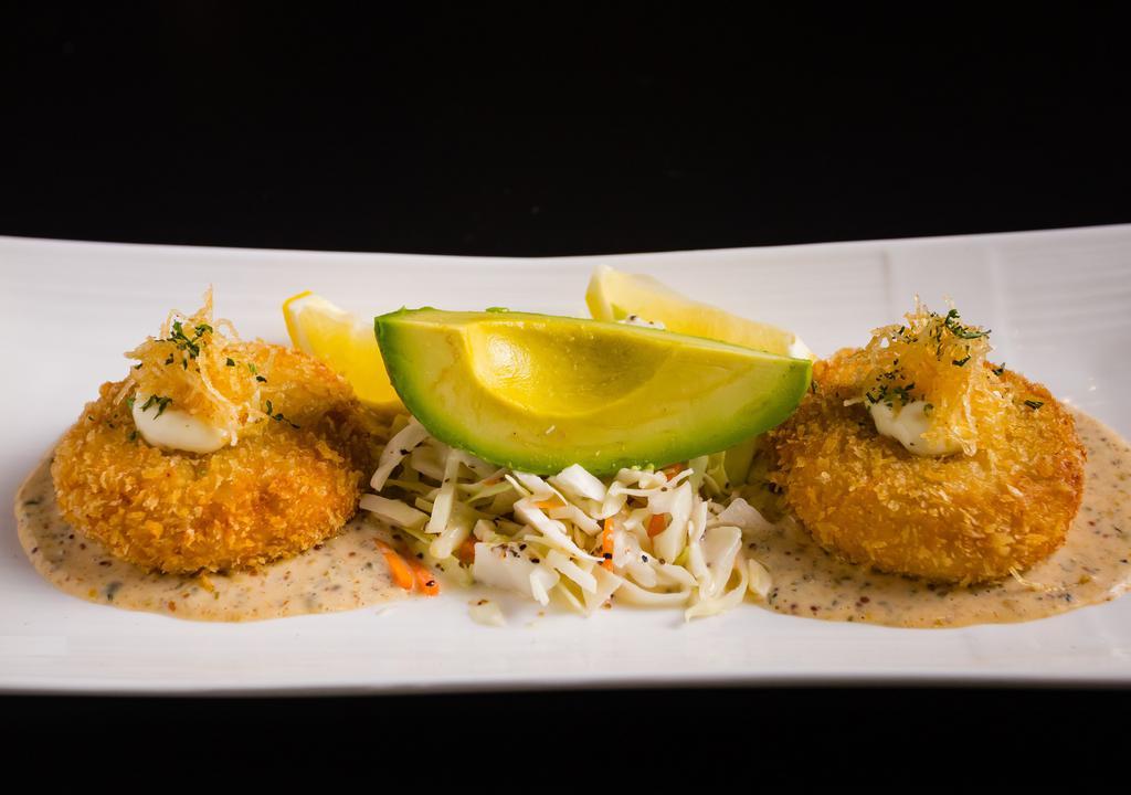 Lump Crab Cakes · Lump crab meat, Dijon, honey, and shallots, severed with homemade “remoulade” sauce and coleslaw.
