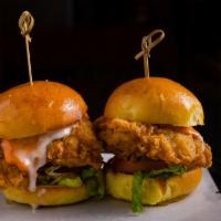 Crispy Chicken Sliders (2) · Sliders with dijon, pickle, tomato, romaine, spicy aioli, and ranch sauce.