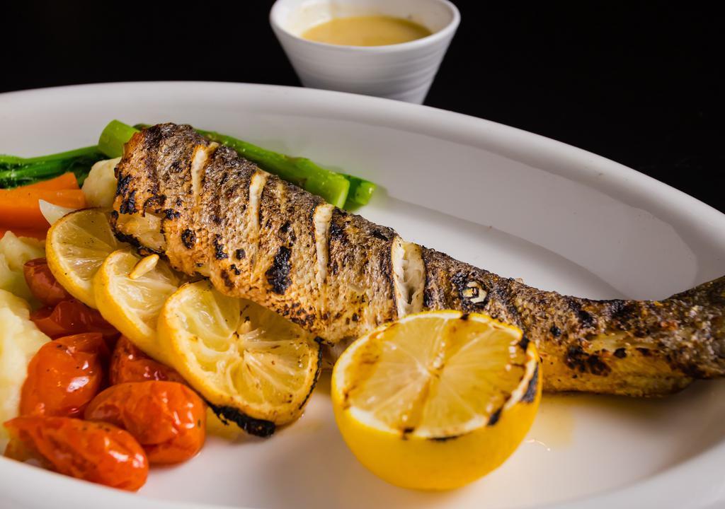 Branzino  · Grilled whole fish with mashed potato. roasted seasonal vegetable and caper lemon garlic butter sauce.