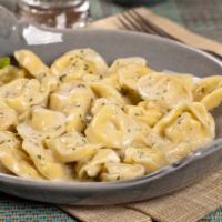 Tortellini Alfredo · Roasted peppers and peas served over tortellini pasta and topped with Alfredo sauce and Parm...