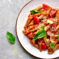 Penne Rustica · Sweet sausage, roasted peppers and onions prepared with a tomato pesto sauce and served over...