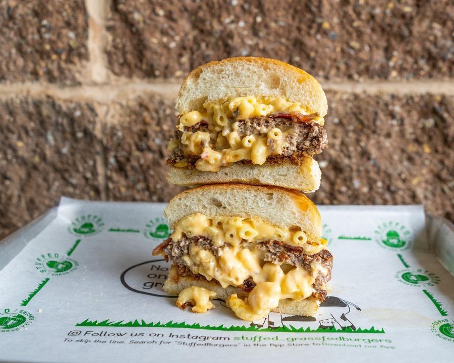Stuffed Mac Burger · A 6.5 oz. Grass Fed Beef Burger stuffed with Mac & Cheese, topped with more Mac & Cheese, Applewood Smoked Bacon, and BBQ Sauce served on a Country White Bun.
