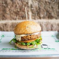 Black Bean Burger · Made with Black Beans, Corn, Red Bell Peppers, and Onion. Topped with Arugula, Tomato, Havar...