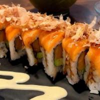 Amber Salmon Roll · Salmon, avocado, cucumber inside topped with salmon and bonito flakes.