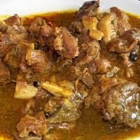 Curry Goat  · Comes with two sides.
