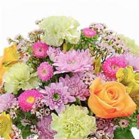 Spring Glory · Long lasting varieties of beautiful blooms, including roses, arranged in a pastel vase.
