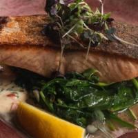 Scottish Salmon Fillet · Served with sauteed baby spinach and beurre blanc sauce.