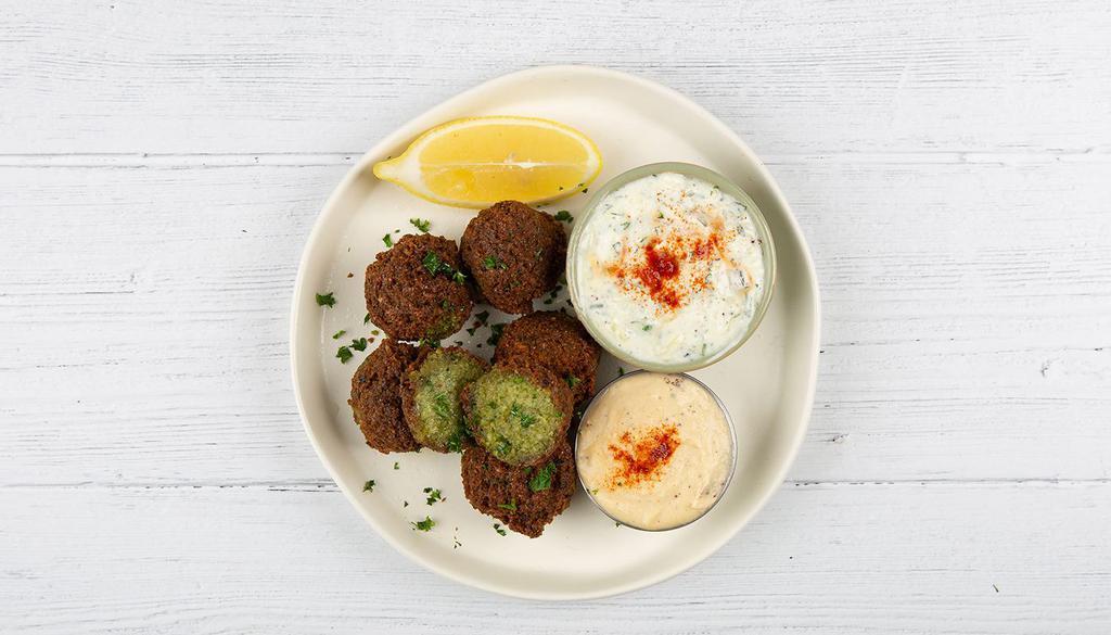 Falafel Plate · Fried falafel balls served with basmati rice, side salad, fresh pita and your choice of sauce.