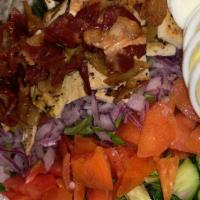 Cobb Salad · Mixed greens or ice berg, boiled egg, bacon, tomato, onion, cucumber, avocado, and blue chee...