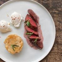 Steak + Eggs · Hanger steak, eggs, potato gratin, and red wine reduction.