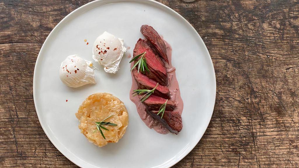 Steak + Eggs · Hanger steak, eggs, potato gratin, and red wine reduction.