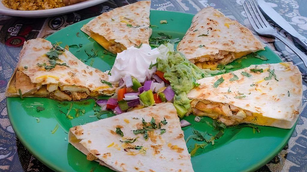 Grilled Chicken Quesadilla · Served with rice & baked pinto beans. Garnished with lettuce, pico de gallo, guacamole & sour cream.