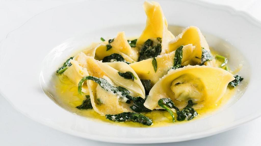 Ravioli Della Casa · handmade ricotta filled ravioli, sauteed spinach, butter and sage