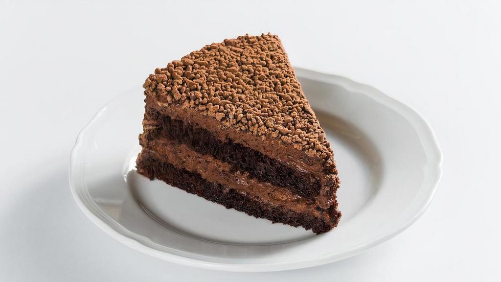 Sant Ambroeus Cake · light chocolate mousse cake with layers of moist chocolate almond sponge, soaked with a light rum syrup, topped with chocolate granules and caramelized cocoa nibs