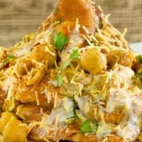 Samosa Chaat · Crumbled samosa mixed with spices. Served with chutney and raita.