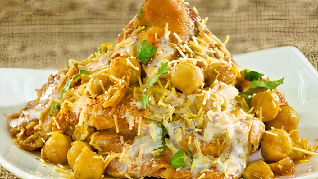 Samosa Chaat · Crumbled samosa mixed with spices. Served with chutney and raita.
