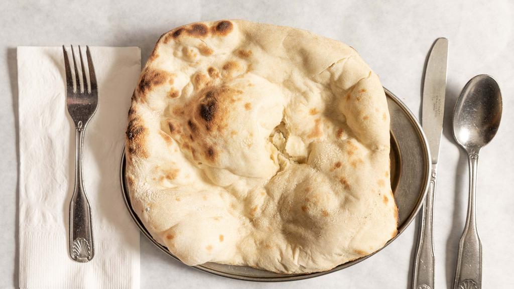 Naan · Favorite. Unleavened bread fresh baked in clay oven.