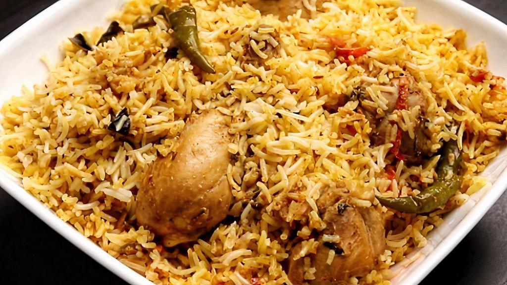Chicken Biryani · Long grain flavored basmati rice cooked with boneless chicken, eggs, nuts, and exotic mild spices.
