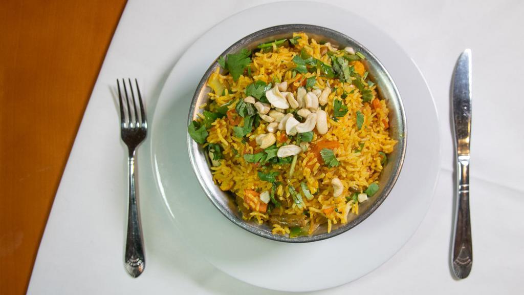 Vegetable Biryani · Distinctly flavored long grain basmati rice cooked with fresh vegetables, nuts, eggs, and mild spices.