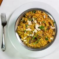 Beef Biryani · Tender pieces of beef cooked with basmati rice, nuts, eggs, and raisins.