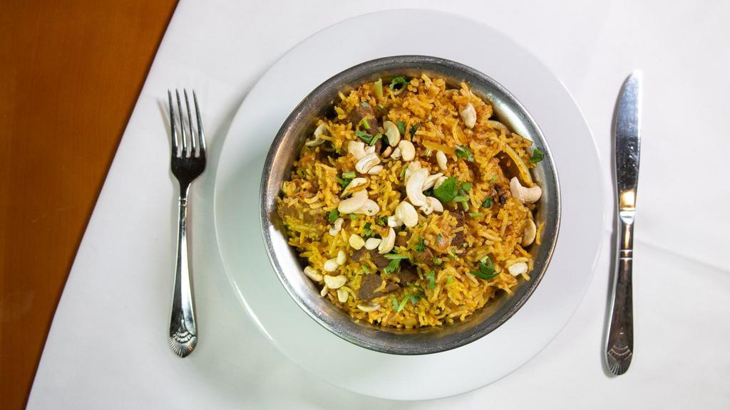 Beef Biryani · Tender pieces of beef cooked with basmati rice, nuts, eggs, and raisins.