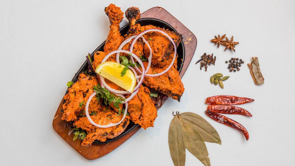 Tandoori Chicken · Half chicken marinated with yoghurt, mild spices and herbs and grilled in tandoor clay oven.