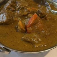 Goat Curry (Bone In) · Goat cubes cooked with onions, tomato and spices.