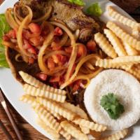 Carne Encebollada · Steak with onions rice and beans.