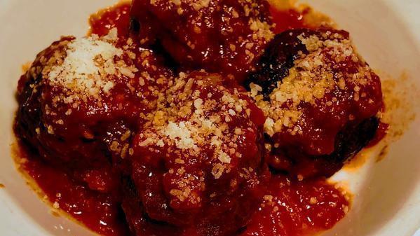 Polpette Al Pomodoro Gratinate · Grass fed beef meatballs, tomato sauce, parmigiano cheese.