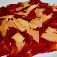 Carpaccio Di Bresaola · Air-dried cured beef (bresaola) carpaccio, shaved parmigiano cheese, evo.