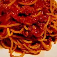 Tagliatelle Alla Bolognese · Homemade spaghetti, grass fed beef ragout, light tomato sauce, parmigiano cheese.