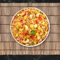 Pineapple Pinnacle · Stir fried rice with egg, pineapple, cashew nut, onion, scallion and tomato.