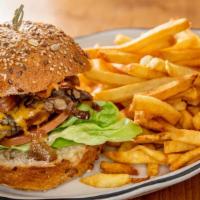 Zaca Beef Burger · Lettuce, caramelized onions, sautéed mushrooms, bacon, tomatoes, pickles, cheddar cheese and...
