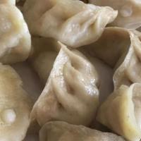 #27 Chasha Momo 8 Pieces · Steamed or pan fried dumplings stuffed with chicken and herbs served with salad (8 pcs)