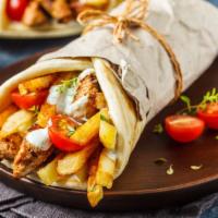Halal Gyro Wrap With Fries · Homemade pita bread filled with beef gyro. Garnished with lettuce, tomatoes, delicious onion...