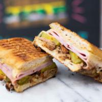 El Cubano · Slow-cooked leg of pork (pernil), smoked ham, swiss cheese, dill pickles, and mustard, press...