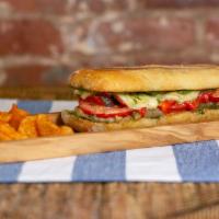 The Veggie · Vegetarian. Roasted red peppers and mushrooms, tomatoes, roasted onions, basil, pesto and mo...