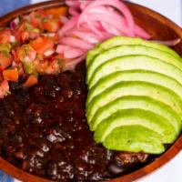 The Veggie Bowl · Black bean chili, sweet plantains, avocado, pico de gallo and pickled red onions on a bed of...